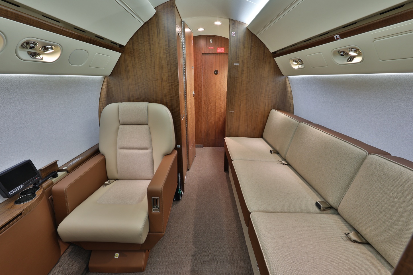 Luxurious interior on jet with leather single chair and elongated couch on Freestream